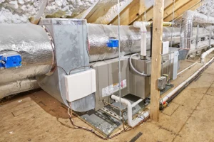 HVAC system installed in an attic with insulated ductwork, condensate lines, and air distribution components. Best for blogs about attic HVAC systems, attic ductwork, HVAC installation in attic spaces, air handler in attic, attic insulation and HVAC efficiency, and ductwork layout and performance.
